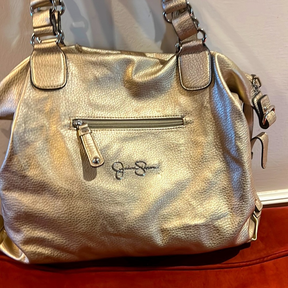 Gold Jessica Simpson purse. Very roomy…can fit lots of items. Gently used.